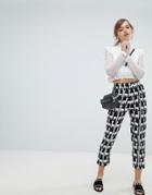 Sister Jane Cigarette Pants With Front Stripe In All Over Llama Print - Black