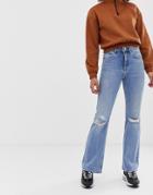 Asos Design Rigid Full Length Flare Jeans With Busted Knee Detail In Mid Stone Wash-blue