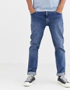 Asos Design Tapered Jeans In Flat Mid Wash Blue