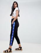 Asos Design Tapered Peg Pants With Geo-tribal Print Side Stripe - Black