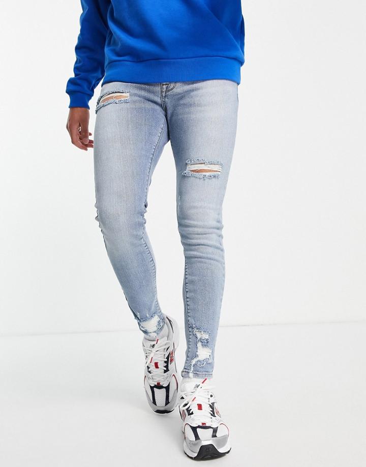 Asos Design Organic Cotton Blend Spray On Jeans With Powerstretch In Mid Wash-blues