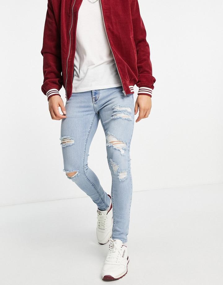 Asos Design Spray On 'vintage Look' Jeans With Powerstretch In Light Wash With Heavy Rips-blues
