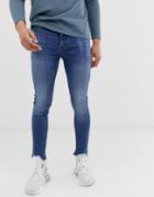 Asos Design Spray On Jeans In Power Stretch With Raw Hem In Blue - Blue