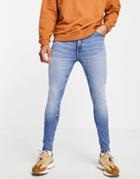 Asos Design Cotton Blend Spray On Jeans With Powerstretch In Mid Wash Blue - Mblue-blues