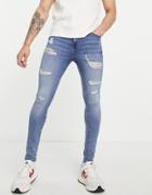 Asos Design Spray On Jeans With Power Stretch In Mid Wash Blue With Heavy Rips-blues