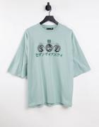 Asos Design Oversized T-shirt In Light Blue With Chest Symbol & Text Print-green