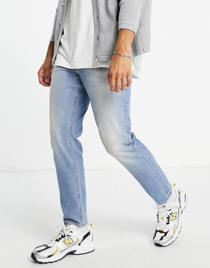 Asos Design Tapered Jeans In Light Wash With Abrasions - Lblue-blues