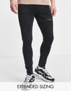 Asos Design Spray On Power Stretch Jeans With Abrasions And Raw Hem In Washed Black