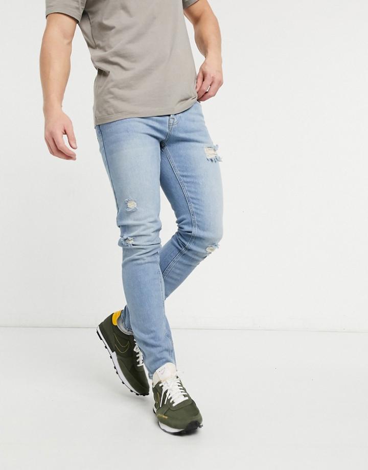 Asos Design Skinny Jeans In Vintage Light Wash With Rips-blue