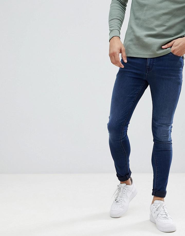 Asos Design Super Spray On Jeans In Dark Wash Blue - Blue