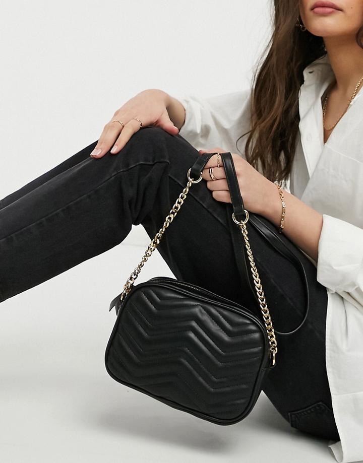 Truffle Collection Crossbody Bag With Zig Zag Quilting And Chain Strap In Black