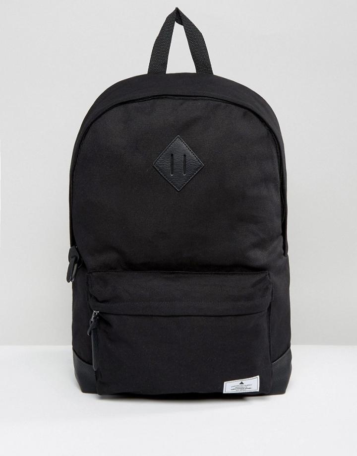 Asos Unrvlld Supply Backpack In Black Canvas With Faux Leather Base And Branded Patch