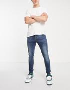 Asos Design Spray On Jeans With Power Stretch In Dark Wash Blue