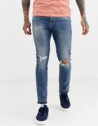 Asos Design Skinny Jeans In Mid Wash Blue With Rips