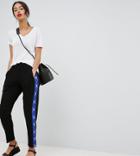 Asos Design Tall Tapered Peg Pants With Geo-tribal Print Side Stripe - Black