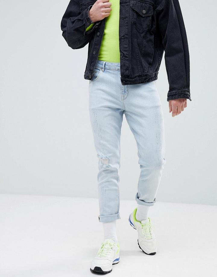 Asos Tapered Jeans In Light Wash Blue With Abrasions - Blue
