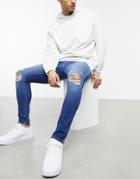 Asos Design Spray On Jeans In Power Stretch With 'less Thirsty' Wash In Mid Blue With Knee Rips-blues