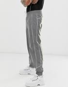 Asos Design Oversized Tapered Sweatpants In Reflective Fabric With Piping-silver