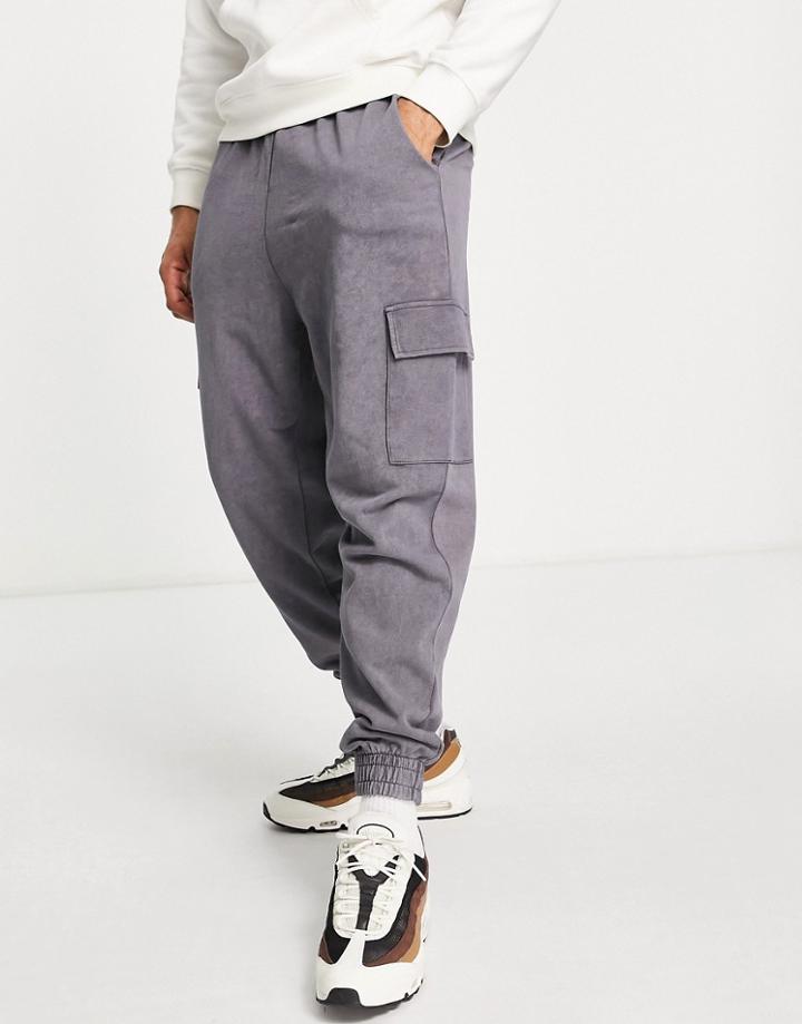 Asos Design Relaxed Sweatpants In Black Acid Wash With Cargo Pocket