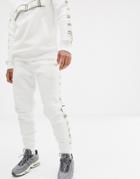 Criminal Damage Skinny Sweatpants In White With Check Side Stripe