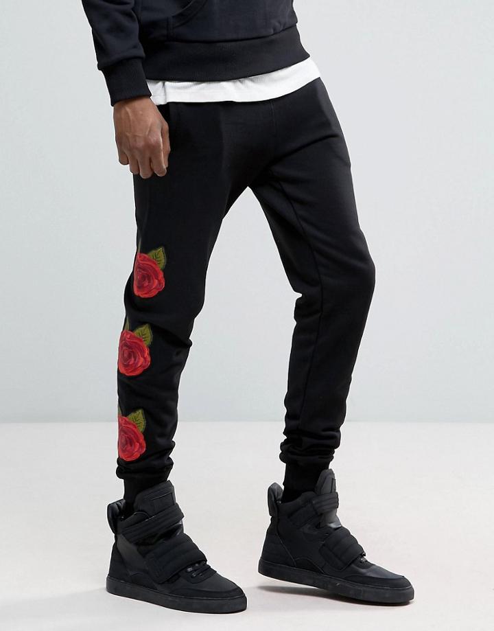 Criminal Damage Skinny Joggers In Black With Rose Print - Black