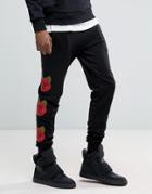 Criminal Damage Skinny Joggers In Black With Rose Print - Black