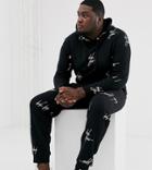 Asos Design Plus Two-piece Tapered Sweatpants With All Over Dark Future Logo Print In Black