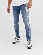 Asos Design Skinny Jeans In Mid Wash Blue With Extreme Rips