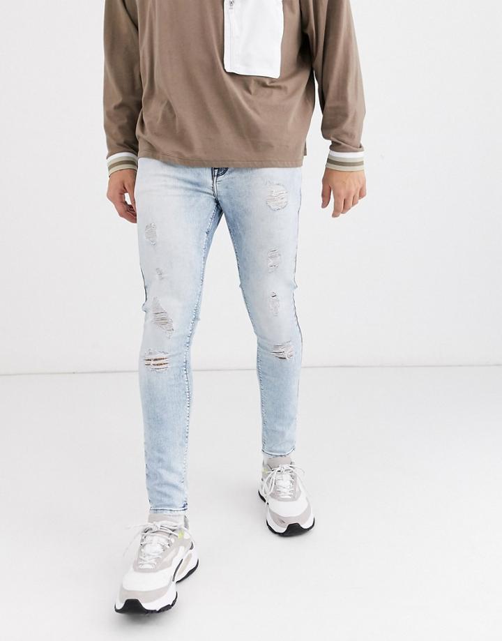 Asos Design Spray On Jeans In Power Stretch In Light Wash With Heavy Rip-blue