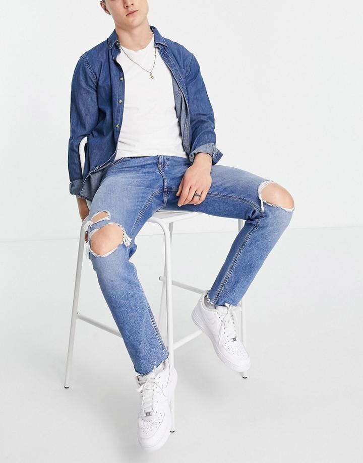 Asos Design Slim Jeans With Knee Rips And Raw Hem In Mid Wash Blue-blues