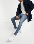 Asos Design Vintage Look Spray On Jeans With Power Stretch In Mid Blue-blues