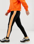 Asos Design Skinny Sweatpants In Black With Orange Side Stripe