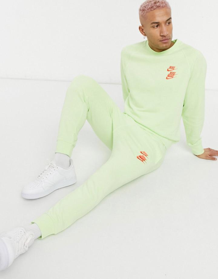 Nike World Tour Pack Graphic Cuffed Sweatpants In Lime-green