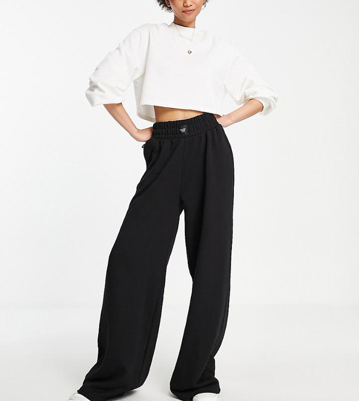 Chelsea Peers Tall High Rise Wide Leg Sweatpants With Woven Logo Tab In Black