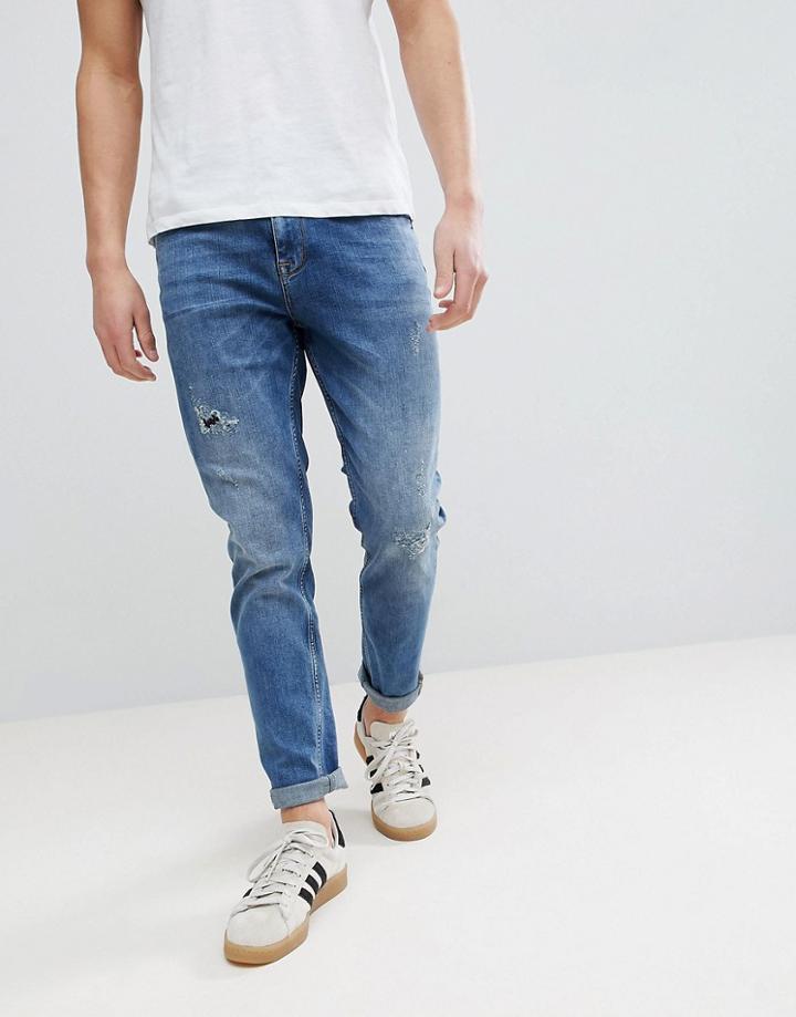 Asos Tapered Jeans In Dark Wash With Rip & Repair - Blue