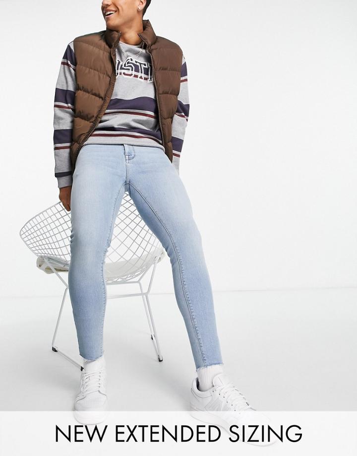 Asos Design Spray On Jeans In Power Stretch In Mid Wash With Raw Hem-blues