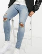 Asos Design Spray On'vintage Look' Jeans With Power Stretch In Mid Wash Blue With Knee Rips