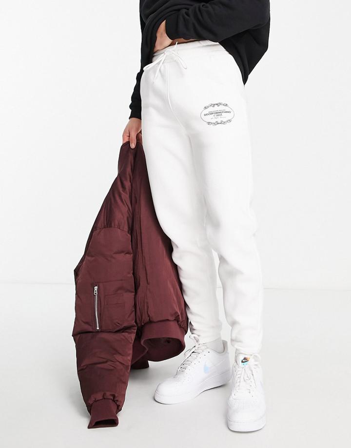 Good For Nothing Sweatpants In Off-white With Crest Logo Print