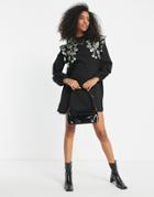 Asos Design Mini Swing Dress With Shoulder Ruffle And Daisy Embroidery In Black
