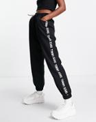 Tommy Jeans Tape Logo Sweatpants In Black
