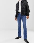 Asos Design Flared Jeans In Mid Blue