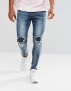 Boohooman Skinny Jeans With Rip And Repair In Mid Wash - Blue