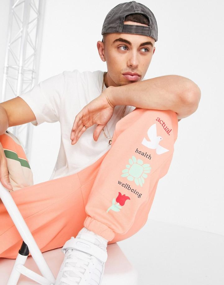 Asos Actual Relaxed Sweatpants With Graphic Print In Orange