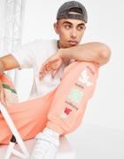 Asos Actual Relaxed Sweatpants With Graphic Print In Orange