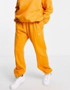 Nike Mini Swoosh Oversized Sweatpants In Orange-yellow