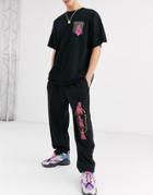Nothing Is Sacred Pink Print Jogger In Black