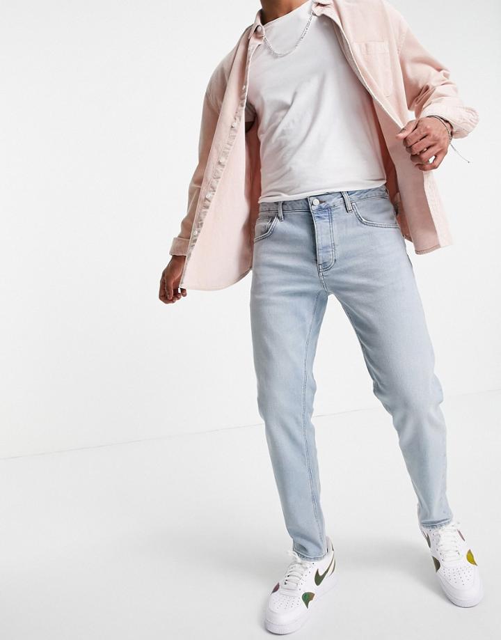 Asos Design Stretch Tapered Jeans In Tinted Light Wash-blues