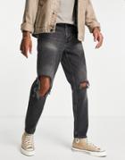 Asos Design Tapered Jeans In Black Wash With Busted Knee Rips