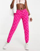 Nike Monogram All-over Logo Print Fleece Cuffed Sweatpants In Pink