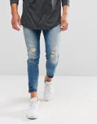 Pull & Bear Carrot Fit Ripped Jeans With Zipped Hem In Mid Wash - Blue